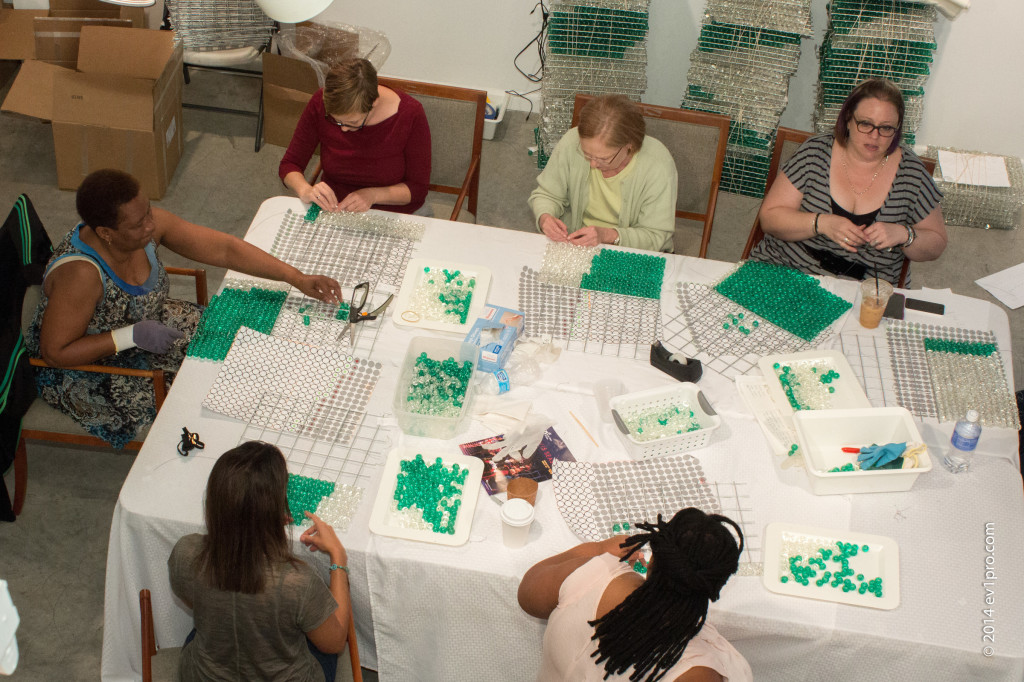 Volunteer beaders at work and communing at Art League Houston. Photo by Juan Islas.