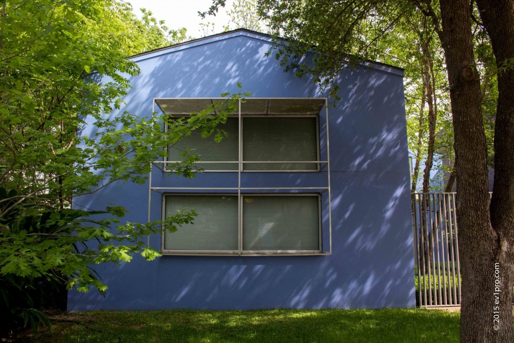 Periwinkle blue studio of architect Carlos Jimenez nestled in the trees.